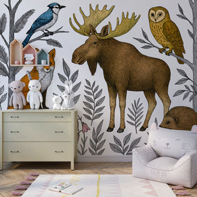 Woodland animals wallpaper featuring fox owl and blue jay in cozy children's playroom setting