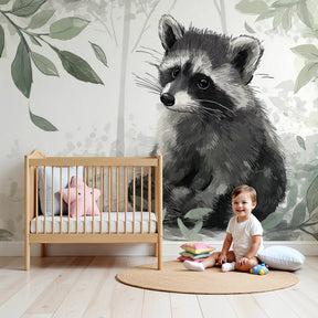 Forest raccoon mural wallpaper in cozy nursery with wooden crib by Kids-Mundo