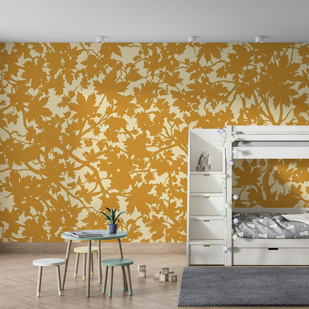 Kids-Mundo maple leaf mural covering a wall behind a child's bed in a warm bedroom