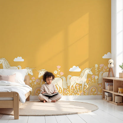 Kids-Mundo golden unicorn herd wall mural styled behind a cot in a sunny mustard nursery