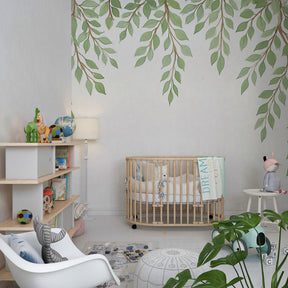 Botanical green leaves wallpaper creating calming atmosphere in modern kids playroom