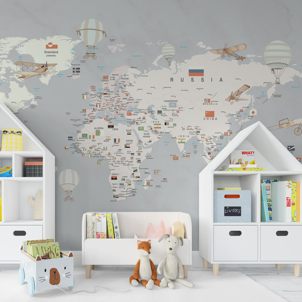 Kids-Mundo grey-tone world map wall mural in a playroom, a calm backdrop for imaginative travel play.