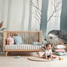Hedgehog forest mural wallpaper in cozy nursery setting with natural wood furniture by Kids-Mundo