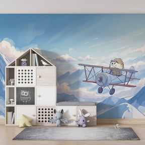 Winter aviation themed mural wallpaper featuring hedgehog pilot in children's playroom setting