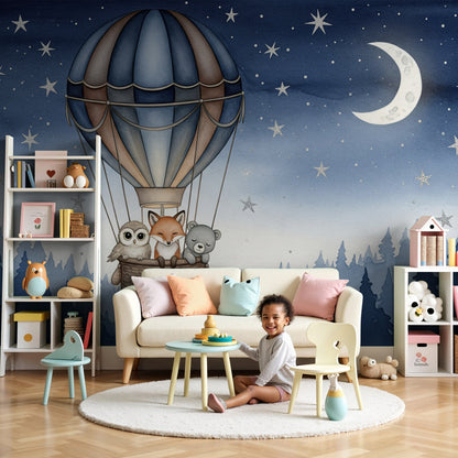 Kids-Mundo hot air balloon night sky wall mural in a soft grey nursery with a cot and warm lighting