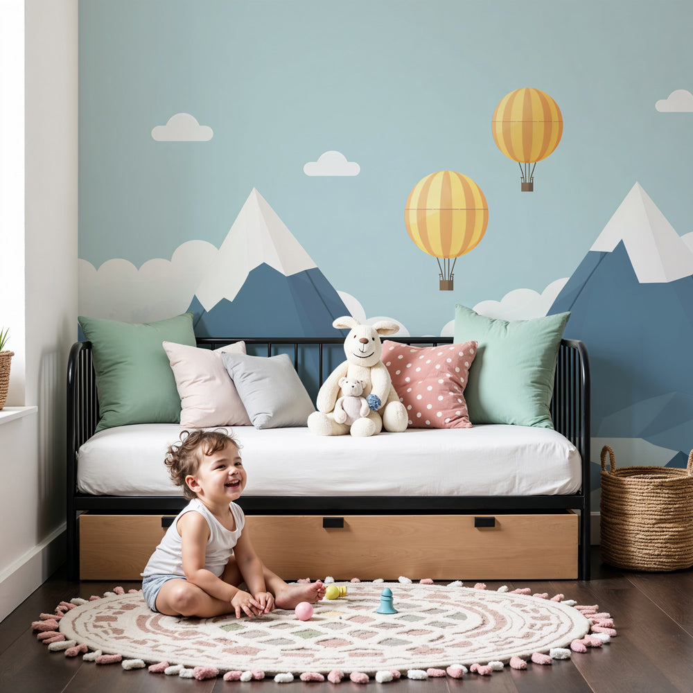 Kids-Mundo hot air balloon mountain wall mural in a calm nursery with a cot and soft neutral decor