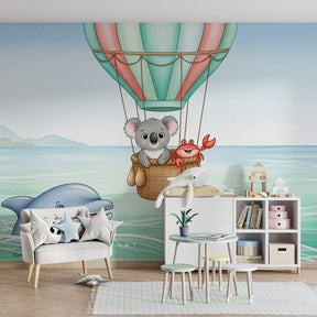 Ocean adventure mural wallpaper with koala and balloon in children's bedroom setting