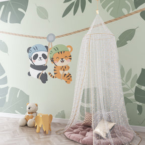Adventure jungle wallpaper creating playful nursery atmosphere with natural wood furniture