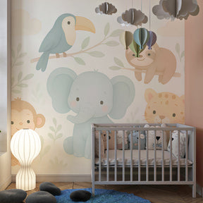 Soft pastel jungle mural wallpaper creating peaceful atmosphere in toddler's room