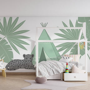Tropical jungle wallpaper creating adventure-themed playroom atmosphere with tent and wildlife