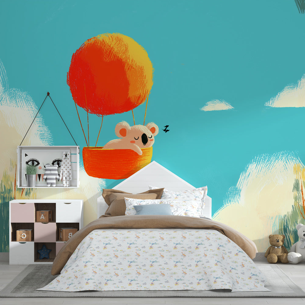 Sky adventure koala mural wallpaper with blue clouds in bright kids playroom space
