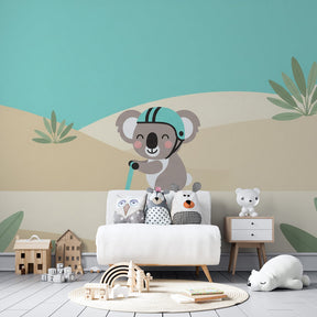 Adventure-themed koala wallpaper creating playful nursery atmosphere with palm trees and pastel colors
