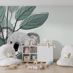Nature inspired koala mural wallpaper in bright kids playroom with wooden furniture