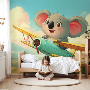 Koala pilot mural wallpaper in modern nursery with wooden crib and blue decor by Kids-Mundo