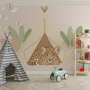 Gentle leopard mural wallpaper with tropical leaves creating peaceful jungle corner in kids room