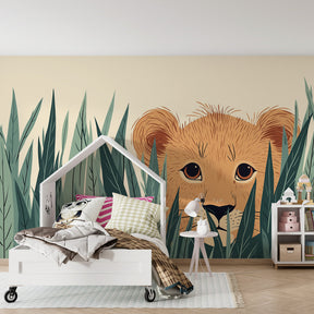 Safari lion cub mural wallpaper with green foliage transforming kids room into jungle adventure