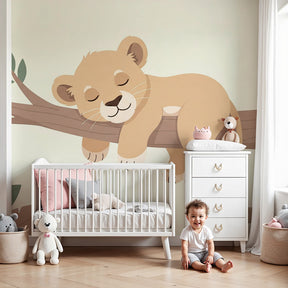 Lion cub mural wallpaper creating peaceful safari nursery decor with sleeping cub on branch by Kids-Mundo