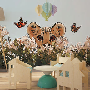 Charming lion and butterfly wallpaper creating magical safari atmosphere in kids bedroom