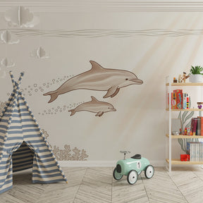 Gentle dolphins mural wallpaper with coral reef creating calming kids playroom atmosphere
