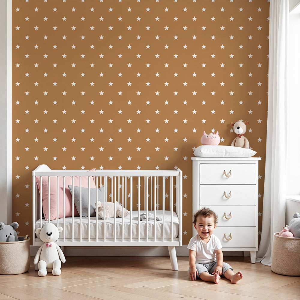 Kids-Mundo mini stars terracotta wall mural styled behind a cot in a cosy nursery