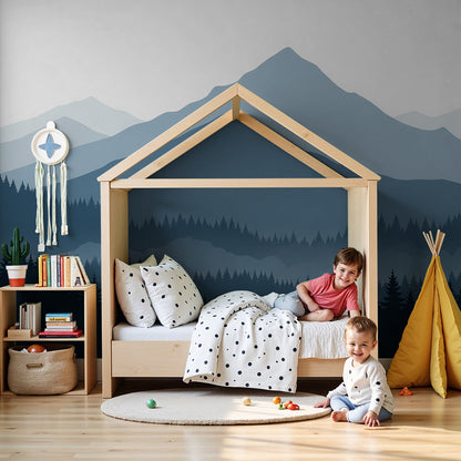 Kids-Mundo blue mountain forest wall mural in a calm nursery with a white cot and soft grey rug