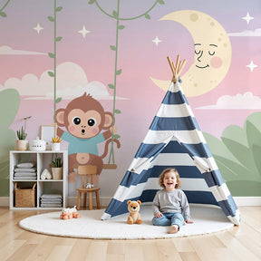 Playful monkey swing mural wallpaper in soft pink nursery with wooden crib by Kids-Mundo