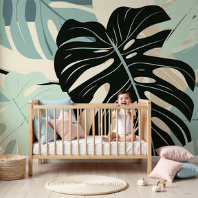 Monstera leaves mural wallpaper in modern nursery with natural wood crib by Kids-Mundo