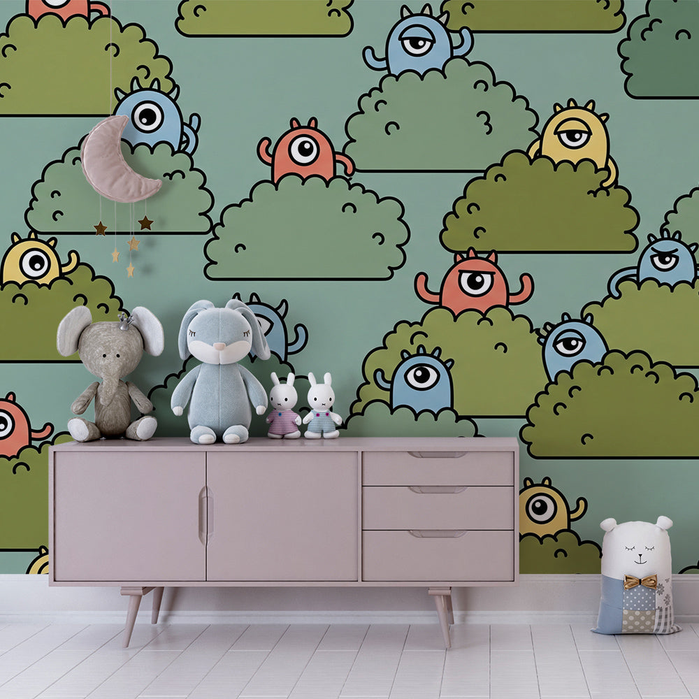 Playroom feature wall with a Kids-Mundo monster wall mural showing playful faces hiding in bushes.