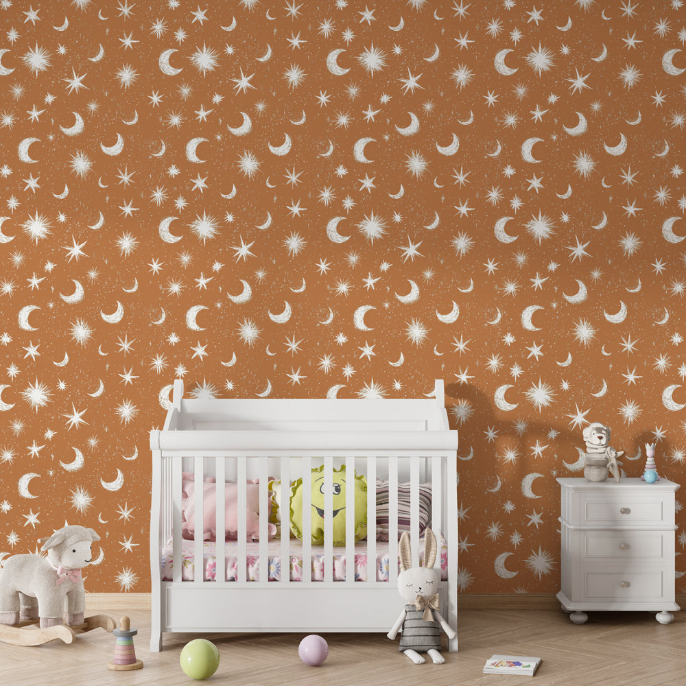 Terracotta celestial wallpaper with golden moons and stars in modern kids bedroom