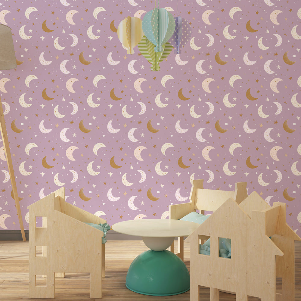 Soft pink celestial wallpaper with moon motifs decorating little girl's bedroom by Kids-Mundo