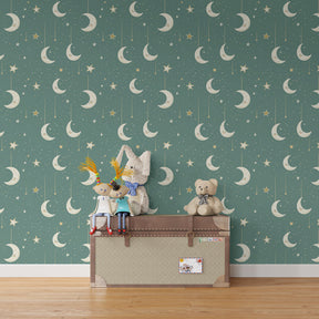 Celestial mural wallpaper with hanging moons and stars in cozy toddler sleep space