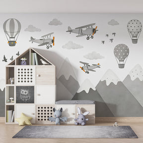 Aviation themed wallpaper creating adventurous kids bedroom decor with mountain landscape