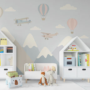 Adventure themed mural wallpaper featuring mountains and flying elements in children's playroom