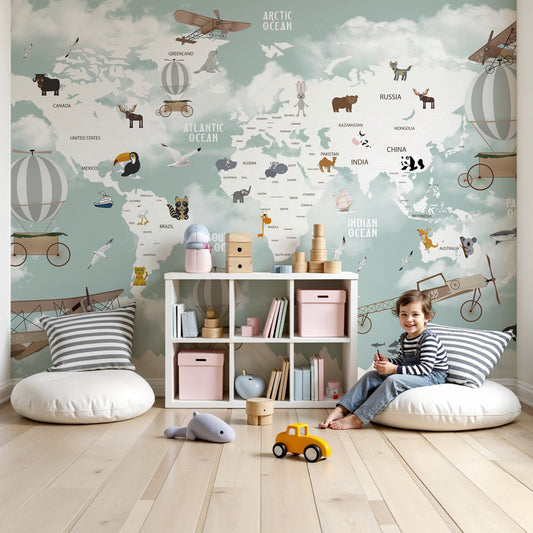 Kids-Mundo mountain world map wall mural in a nursery, pandas and toucans among snowy peaks above the cot.