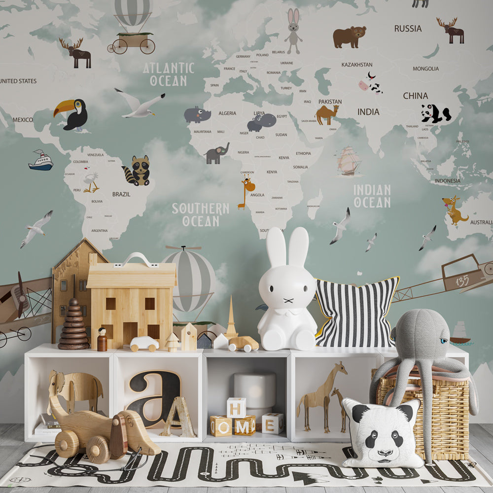 Kids-Mundo world map wall mural in a playroom, striped balloons and biplanes drifting above mountain peaks.