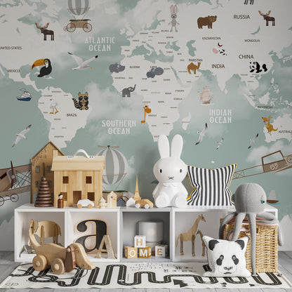 Kids-Mundo world map wall mural in a playroom, striped balloons and biplanes drifting above mountain peaks.