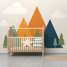 Mountain landscape wallpaper creating adventure-themed nursery with pine trees and clouds