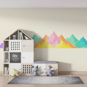 Vibrant mountain mural wallpaper transforming playroom with colorful landscape design