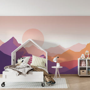 Pastel mountain mural wallpaper with sunset colors in children's reading corner
