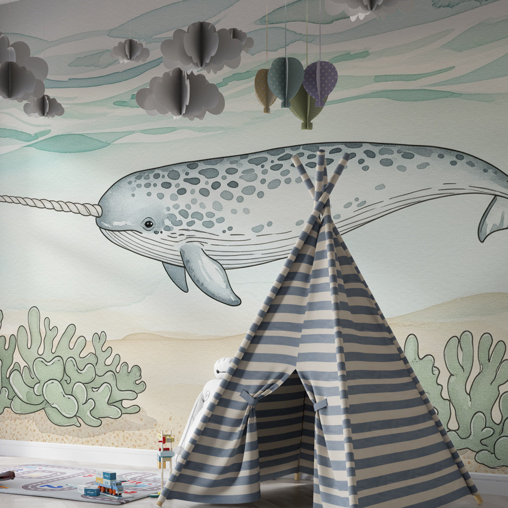 Ocean themed narwhal mural wallpaper with coral details in bright kids playroom setting