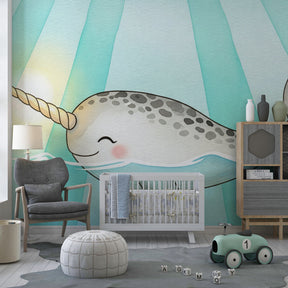 Ocean themed narwhal mural wallpaper in modern baby nursery with soothing blue decor