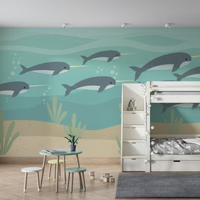 Marine life mural wallpaper featuring swimming narwhals in turquoise ocean playroom setting