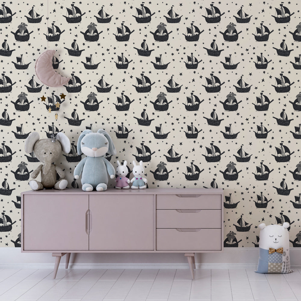Maritime themed mural wallpaper featuring sailboats and stars in monochrome kids playroom setting