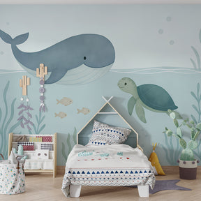 Whale and turtle wallpaper creating calming underwater theme in children's bedroom