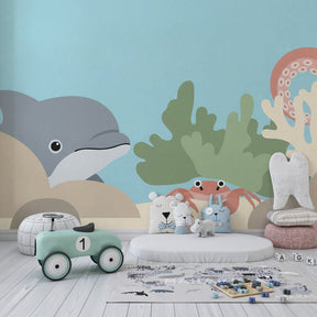 Underwater dolphin and crab wallpaper creating calming nursery atmosphere with marine theme