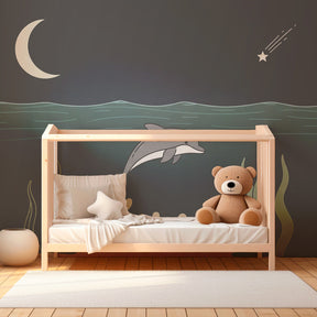 Marine themed wallpaper with dolphin and stars creating serene kids bedroom atmosphere