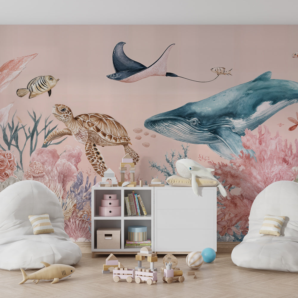 Pastel ocean wallpaper featuring whale and sea creatures in bright kids playroom setting