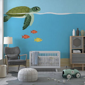 Sea turtle and fish mural wallpaper transforming toddler room into underwater paradise