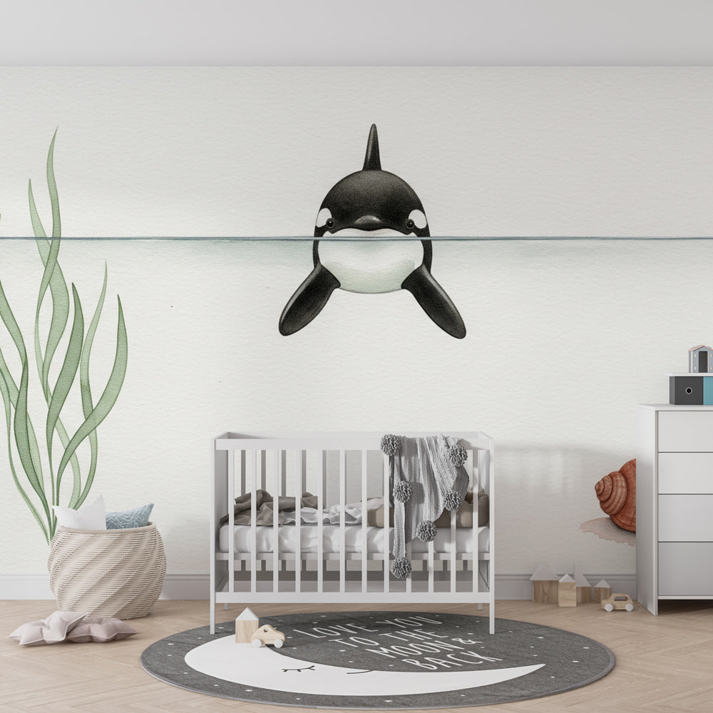 Ocean themed mural wallpaper with gentle orca whale creating peaceful toddler room decor