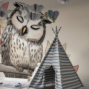 Soft woodland owl mural wallpaper complementing beige nursery theme with cozy reading corner